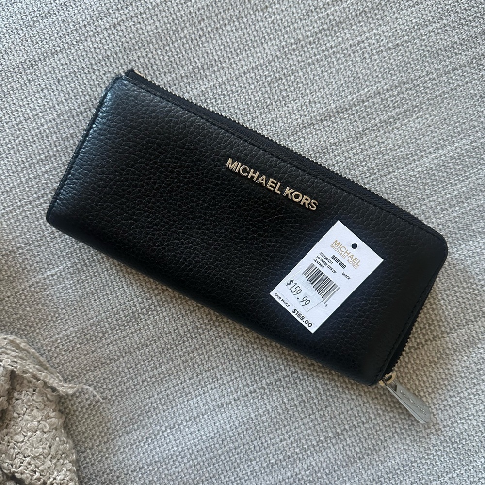 Michael Kors black leather women’s wallet.
